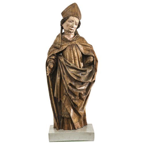Hl. Bischof. Süddeutsch, 15./16. Jh. Holz, Reste von Farbfassung, rücks. gehöhlt. Hand und Finger fehlen. H. 80 cm.