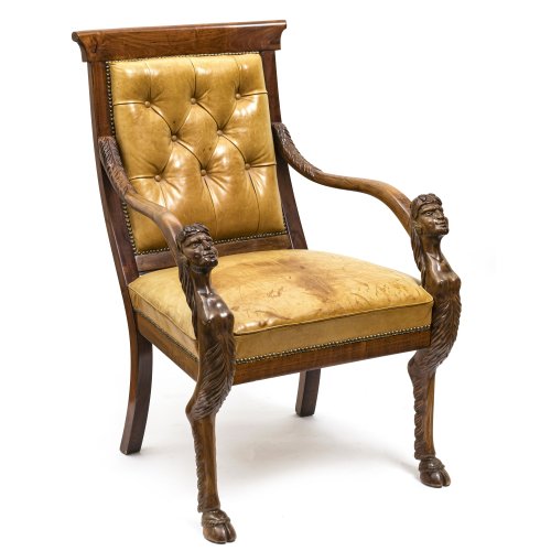 Sessel. England, 19. Jh. Mahagoni furniert. Lederbezug. Armlehnen mit Kentauren, Stuhlbeine vorderseitig bocksbeinig. H. 99 cm. Sitzhöhe 50 cm.