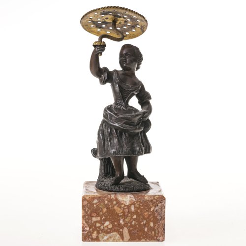 Hutnadelhalter. Deutsch, 19. Jh. Galante Mädchenfigur aus Bronze auf Granitblock montiert. In der Hand haltend ein beweglicher Schirm aus Messing mit Vorrichtungen für die Haarnadeln. H. ca. 20 cm.