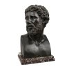 Büste eines Römers. Bronze. H. 48 cm, mit Sockel 53 cm. Rücks. Monogr.: WB und bez.: C. Rauch. Auf Steinsockel montiert.