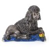 Nymphenburg, ca. 1950-59.  Stattlicher Königspudel auf Teppich mit Spielball. Porzellan, farbig staffiert. Ca. 7,7 x 9,5 x 6,5 cm. Minim. Abrieb.
