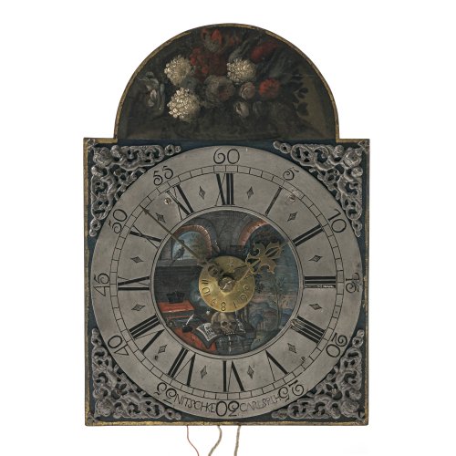 Eisenuhr. Nitschke, Karlsruhe. Zifferblatt bemalt, mit Vanitasstillleben. Mit Pendel, Wandhalterung, 2 Gewichte und 2 kleine Gegengewichte. Alterungsspuren, verändert. 39 x 28 x 12 cm.