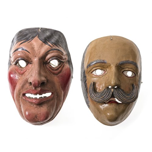 Zwei Perchtenmasken. Holz, geschnitzt, farbig bemalt. Männerköpfe, einer mit Bart. Alterungsspuren. H. 22-24 cm.