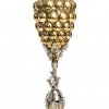 Ananaspokal. Silber, vergoldet. Schaft in Form eines Baumstrunkes mit Waldarbeiter, als Knauf Knospe aus Silberspänen. Neu vergoldet und versilbert. Ca. 495 g. H. 34,5 cm.